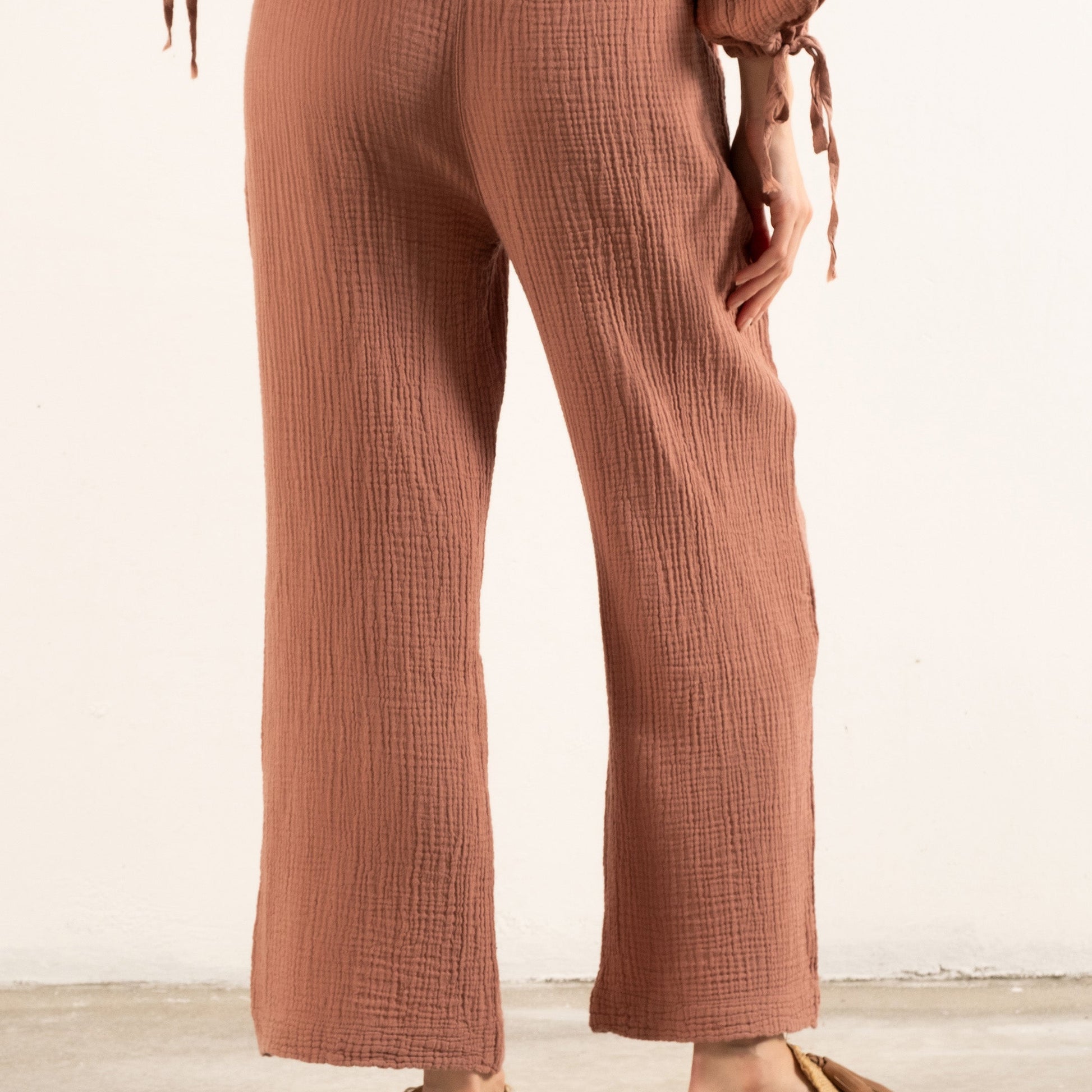 woman with dusty rose muslin pants