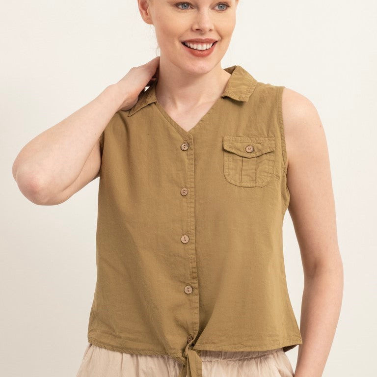 A woman modeling a sleeveless button-front top in a muted olive-brown/khaki color, paired with light beige bottoms, against a plain light background.
