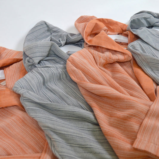 turkish cotton robes with orange and blue stripes on a white background