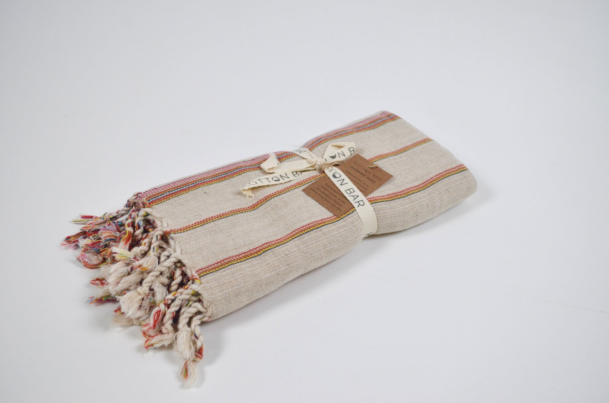 Textured towel with tassels on a white background
