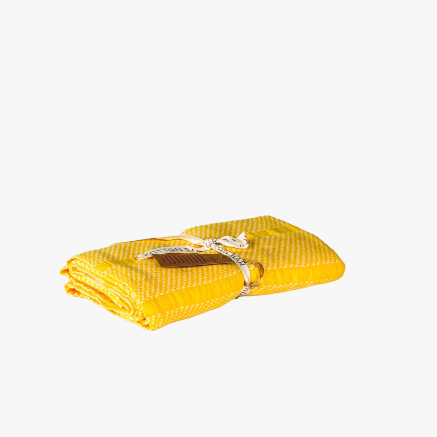 Yellow folded towel with a brand label on a light gray background