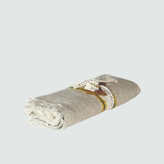 Rolled-up towel with a label on a gray background