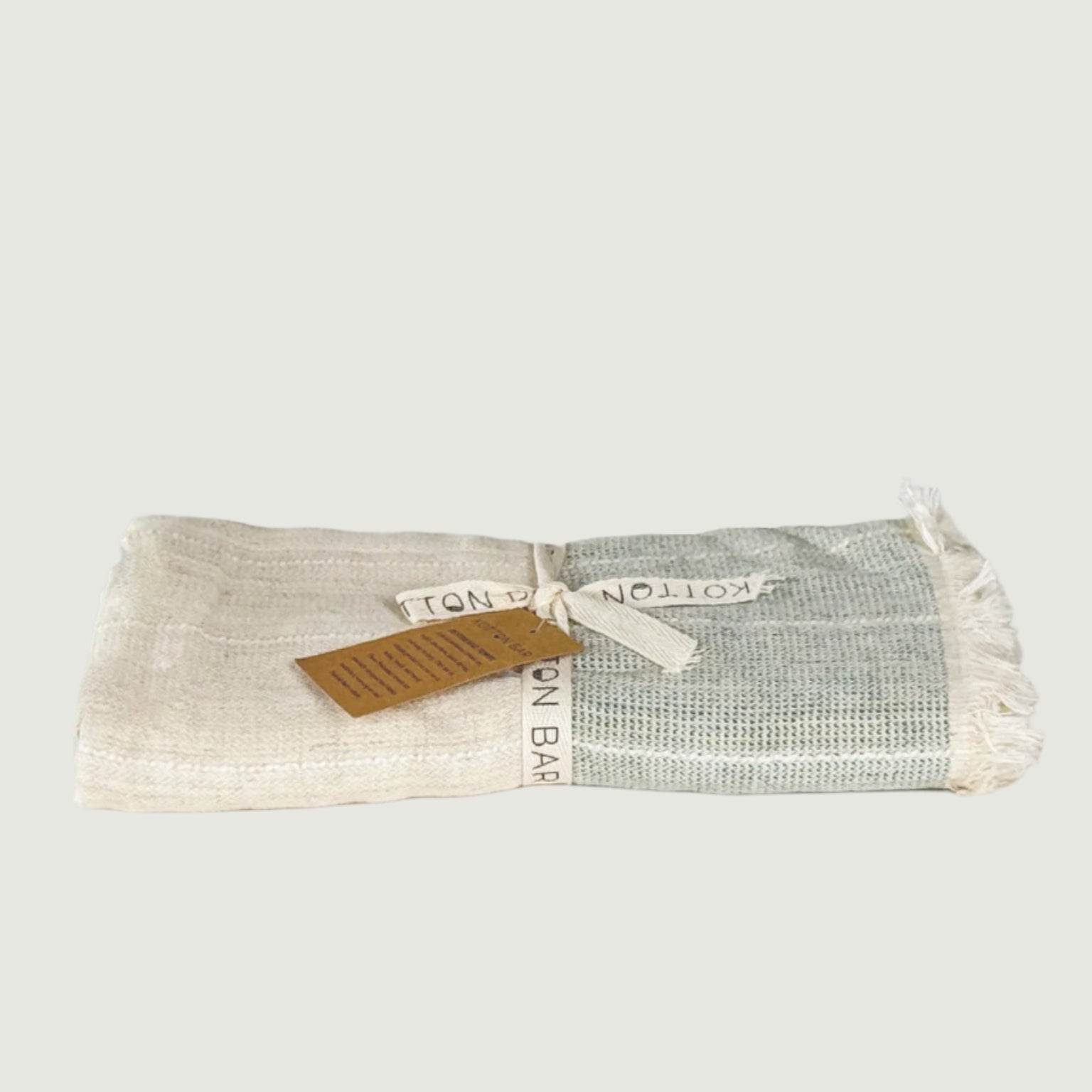 Folded fabric with a label on a light gray background