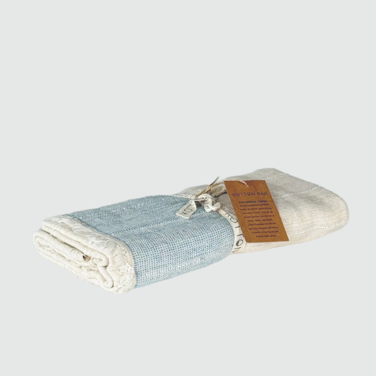 Folded fabric with a brown label on a gray background