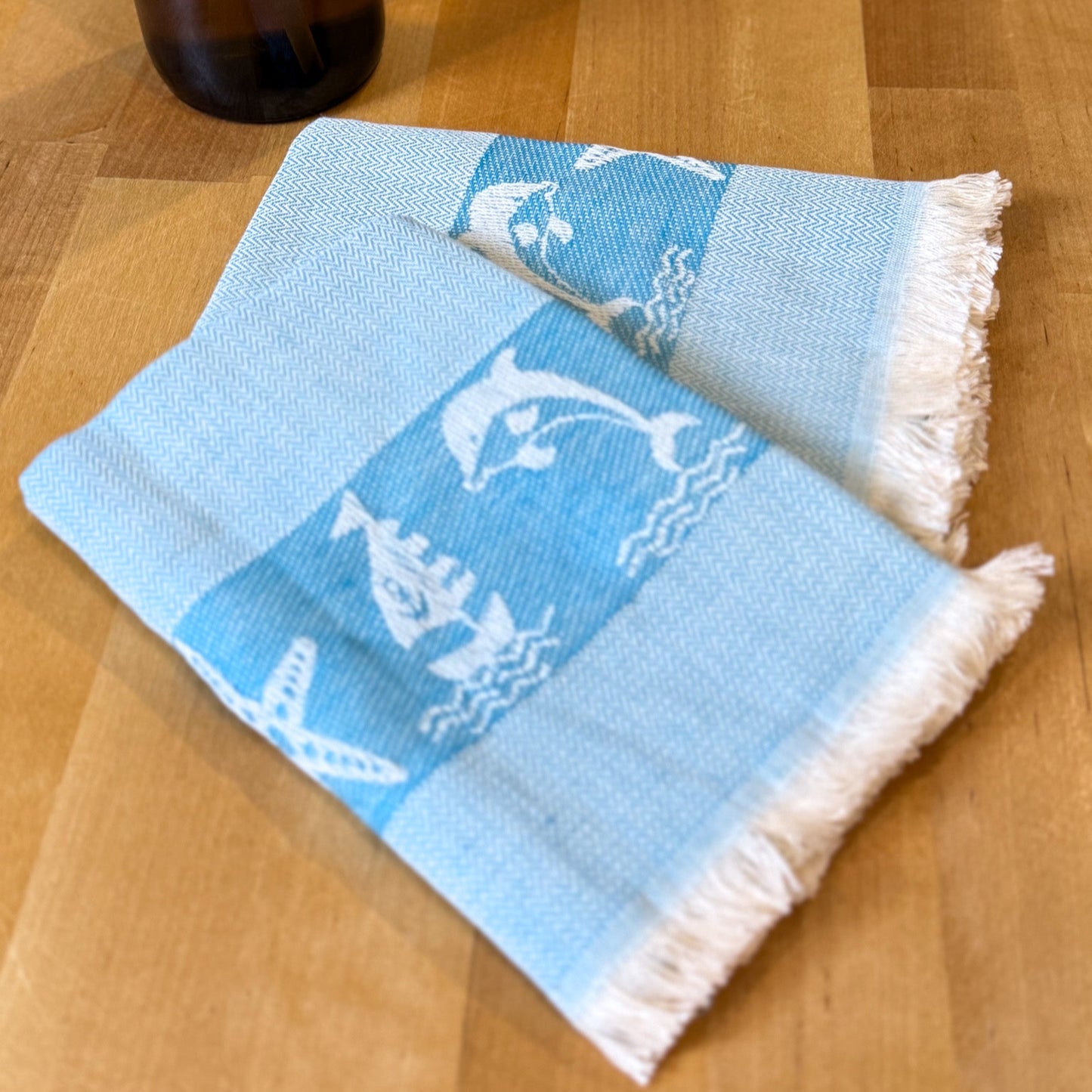 Blue towel with white patterns on a wooden surface