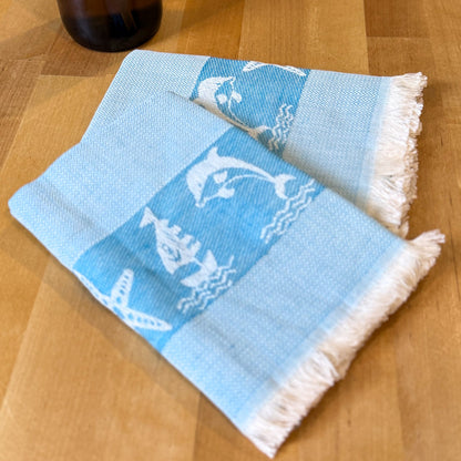 Blue towel with white patterns on a wooden surface