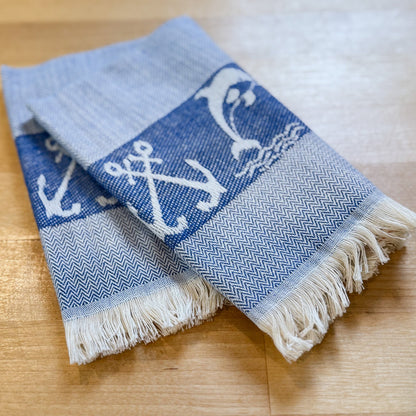 Folded towel with anchor pattern on a wooden surface